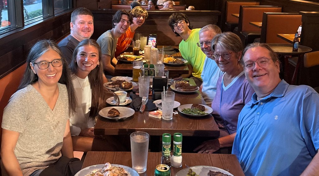 Family gathered around the table at Outback Steakhouse in Lithia, Florida, the evening before Jeannie and Skip flew to Los Angeles.